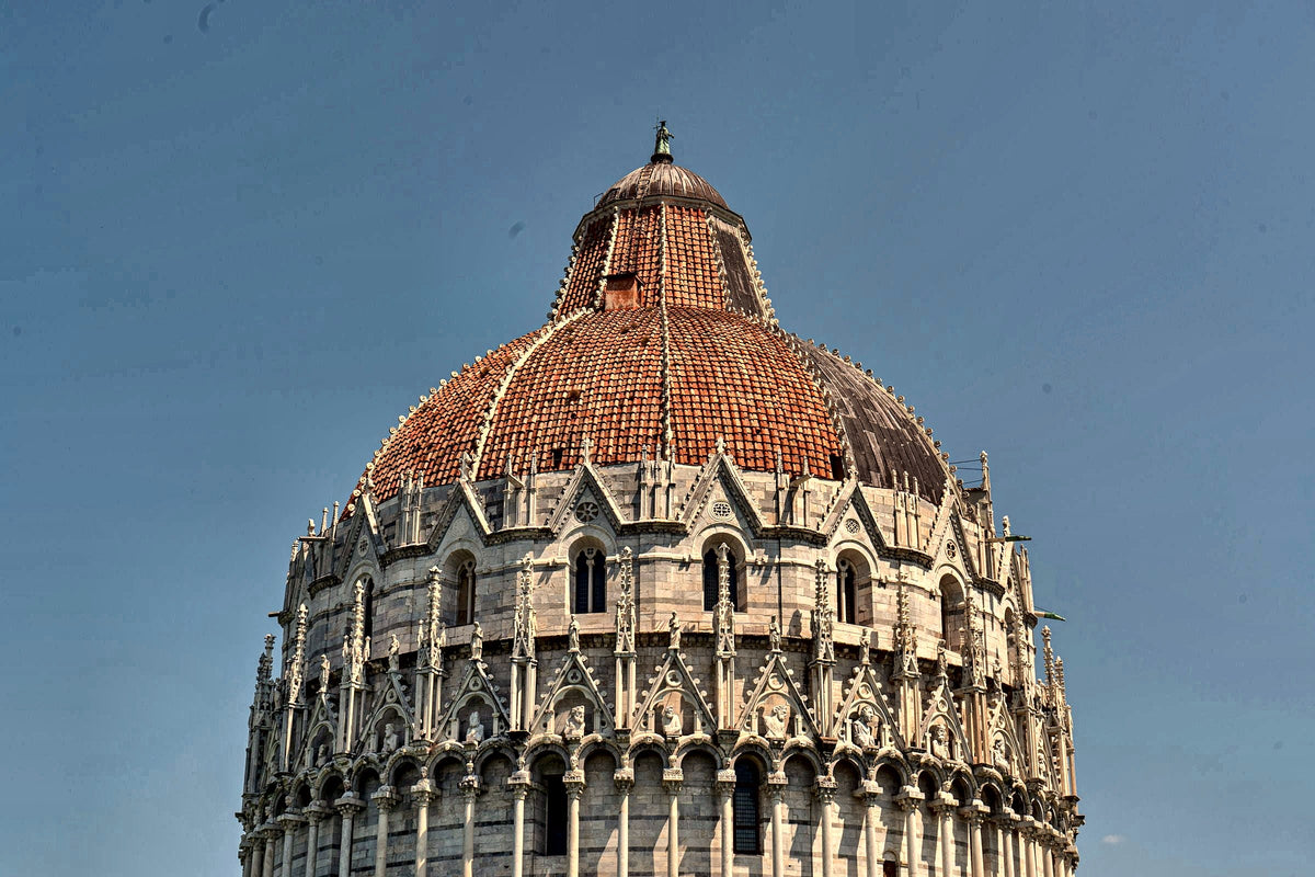 The red-tiled dome of the Baptistery against the sky