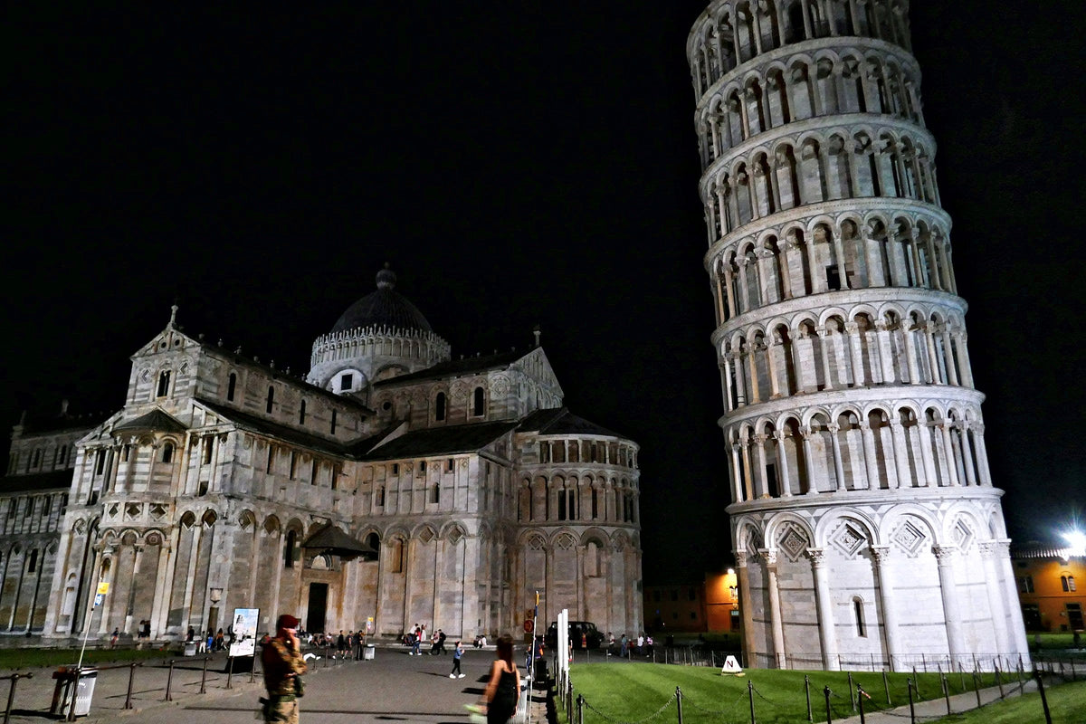 The cathedral and the leaning tower floodlit at night