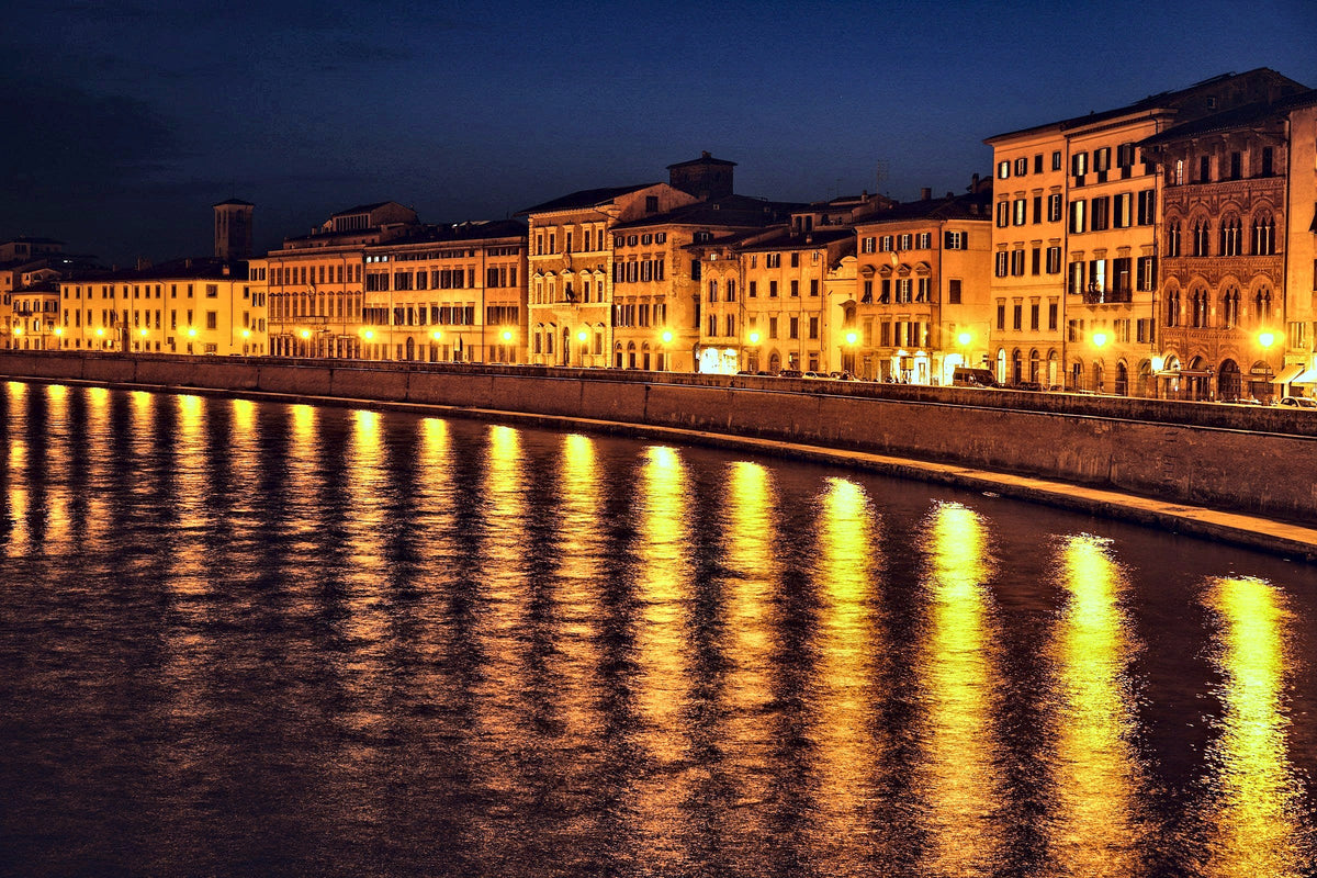Palazzi along the Arno glowing after dark
