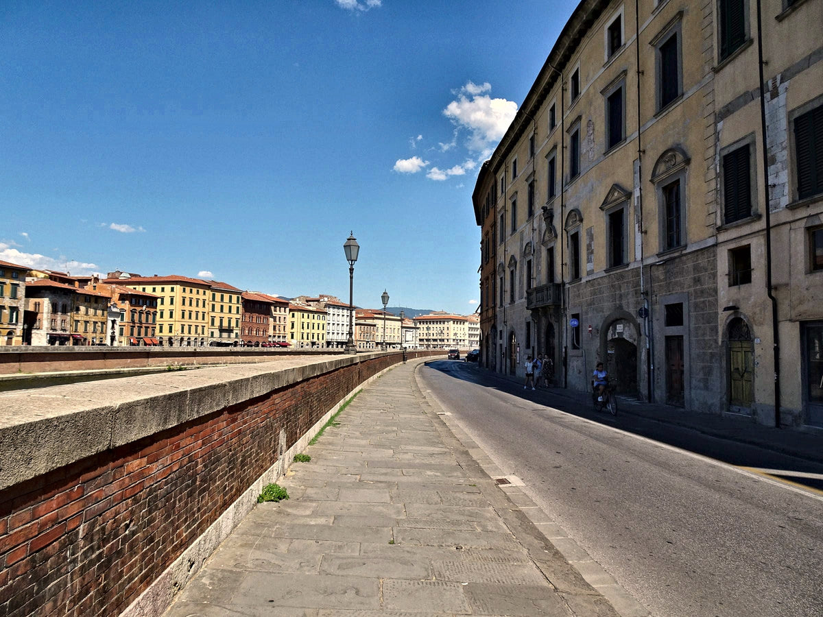 A sunny morning on the Lungarno, the river wall in old brick