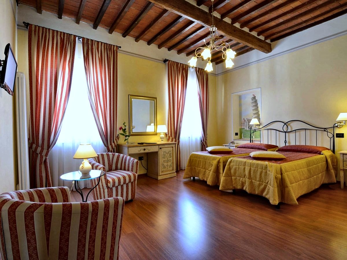 A Deluxe room under wooden beams at Hotel Di Stefano
