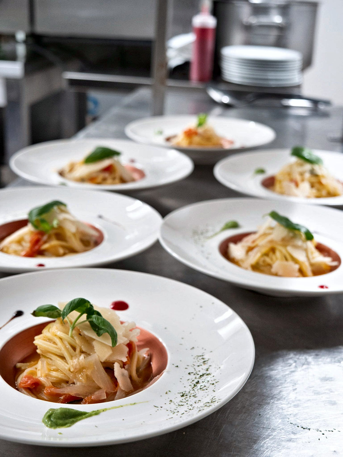 Plates of pasta lined up at the pass at Grand Hotel Duomo