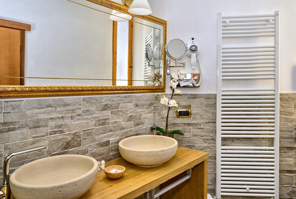 A stone-washbasin bathroom at Hotel Maria