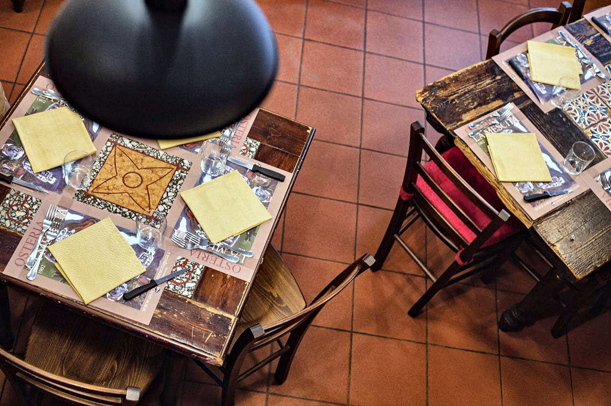 Tiled tables laid for dinner at Osteria La Mescita