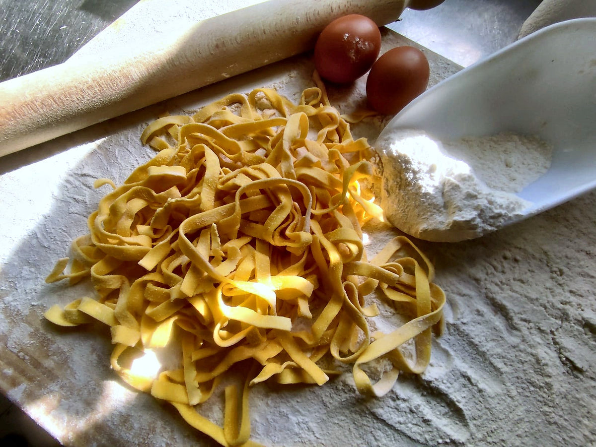 Fresh tagliatelle on the pastry board at Sugo e Camicia