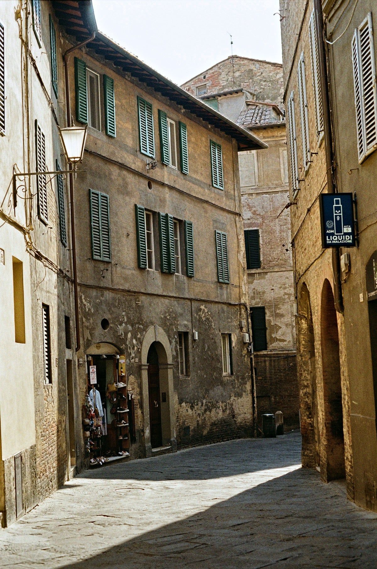 A quiet lane with green shutters