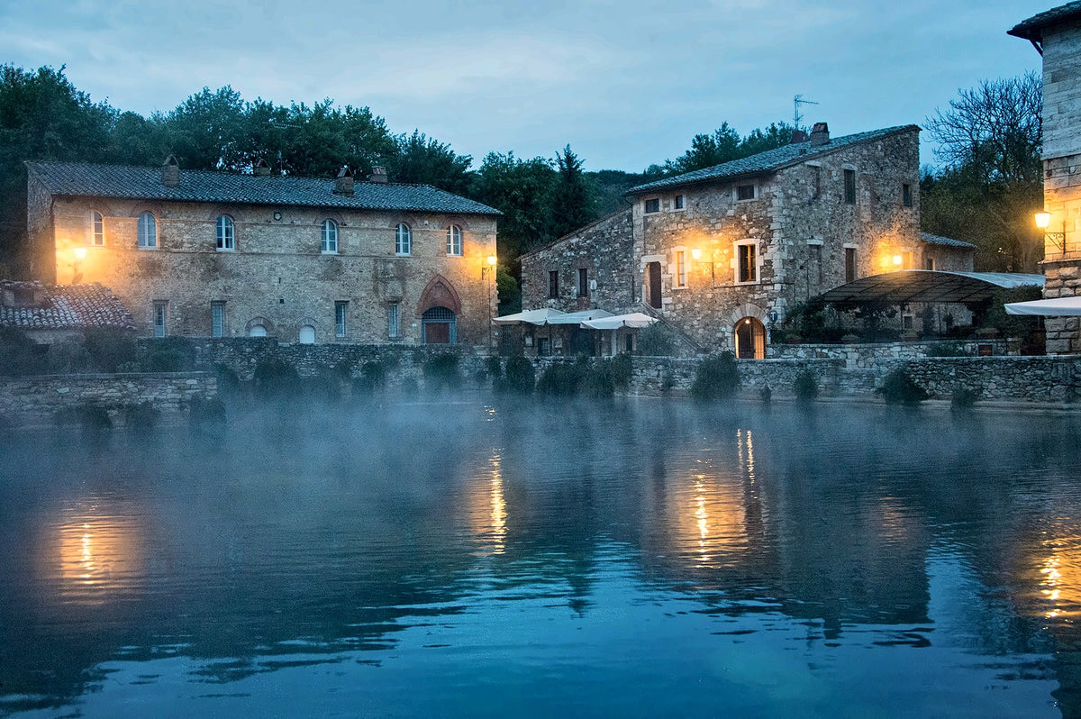 Steam rising from Bagno Vignoni’s pool at dusk