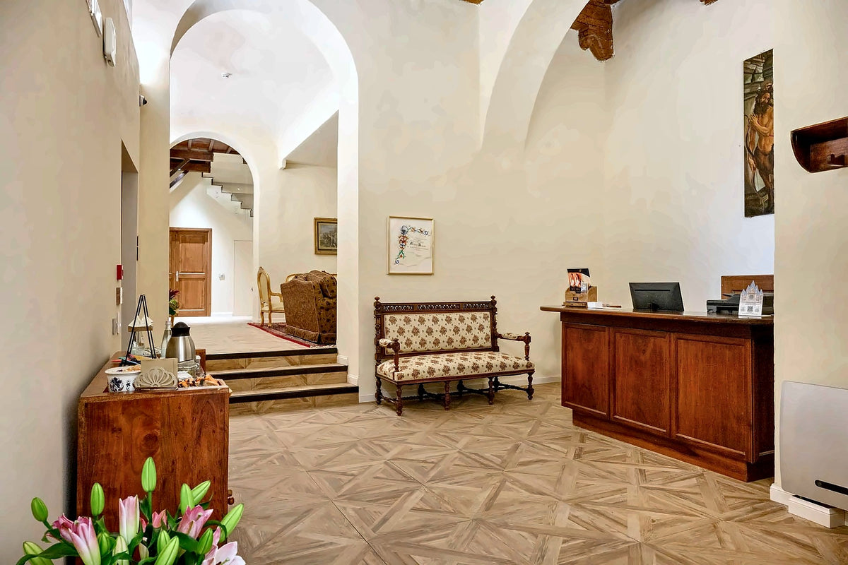 Reception and lounge under white vaults at Palazzo Patrizi
