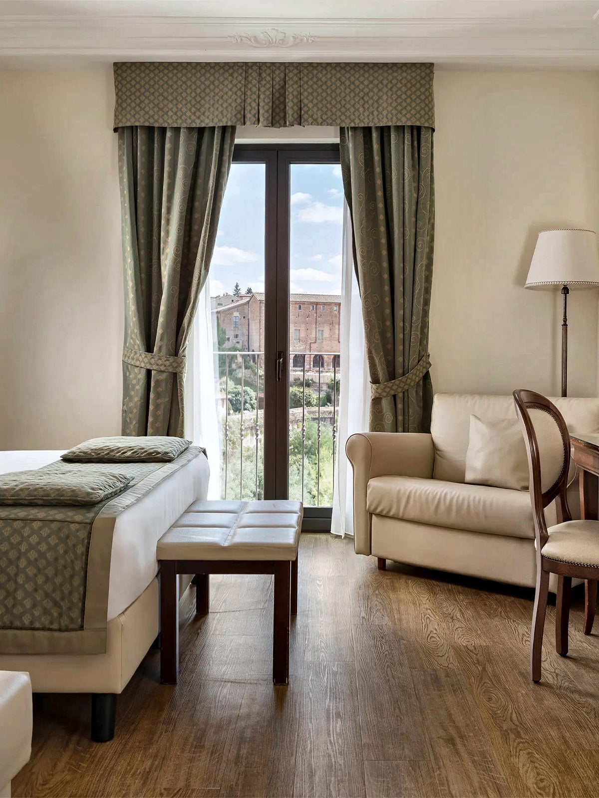 Room with a balcony door and a view of the old town at Hotel Athena