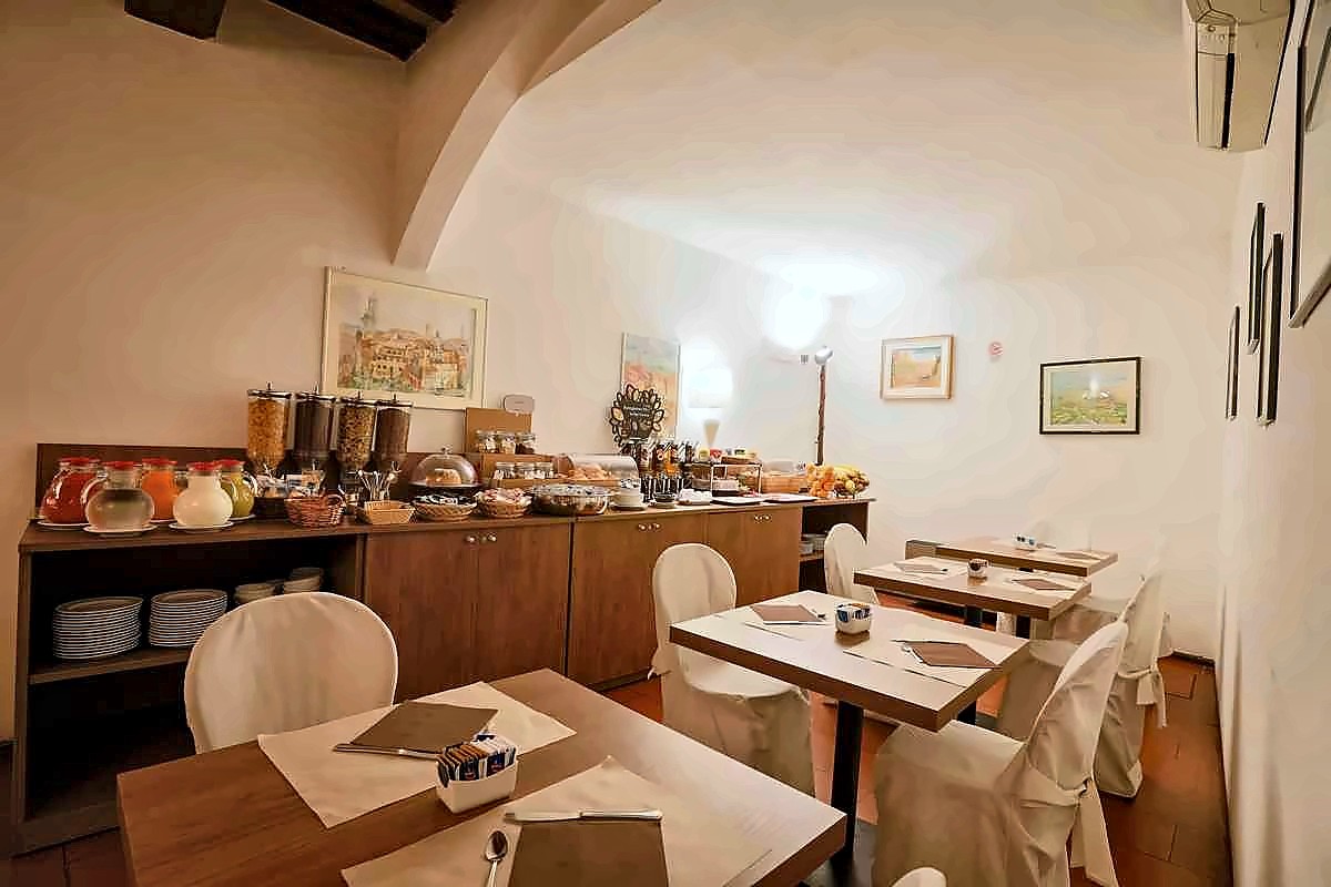 Breakfast buffet and tables at Hotel Duomo