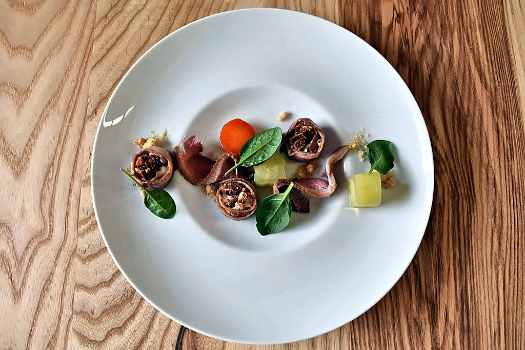 Plated meat starter with vegetables at Campo Cedro