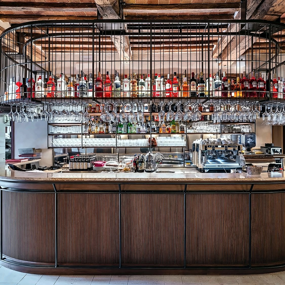 Bar counter with backlit bottle shelves at Il Bandierino