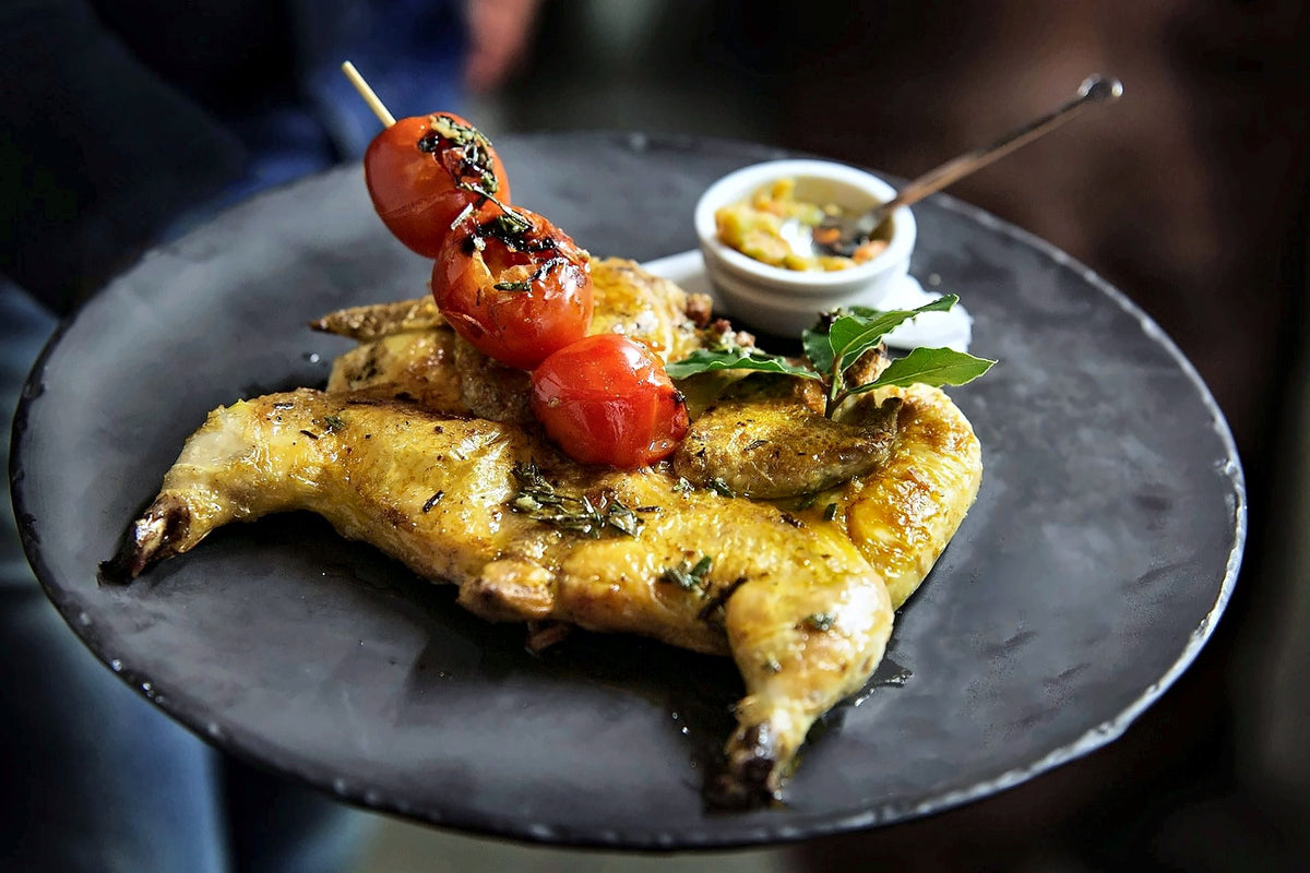 Roast poultry with a cherry tomato skewer at La Taverna di San Giuseppe