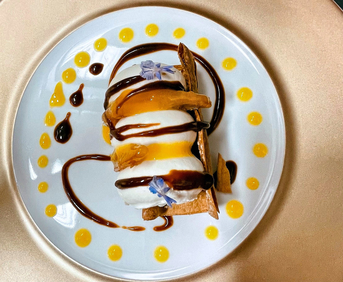 Plated dessert with chocolate and fruit sauce at L’Orto & un Quarto