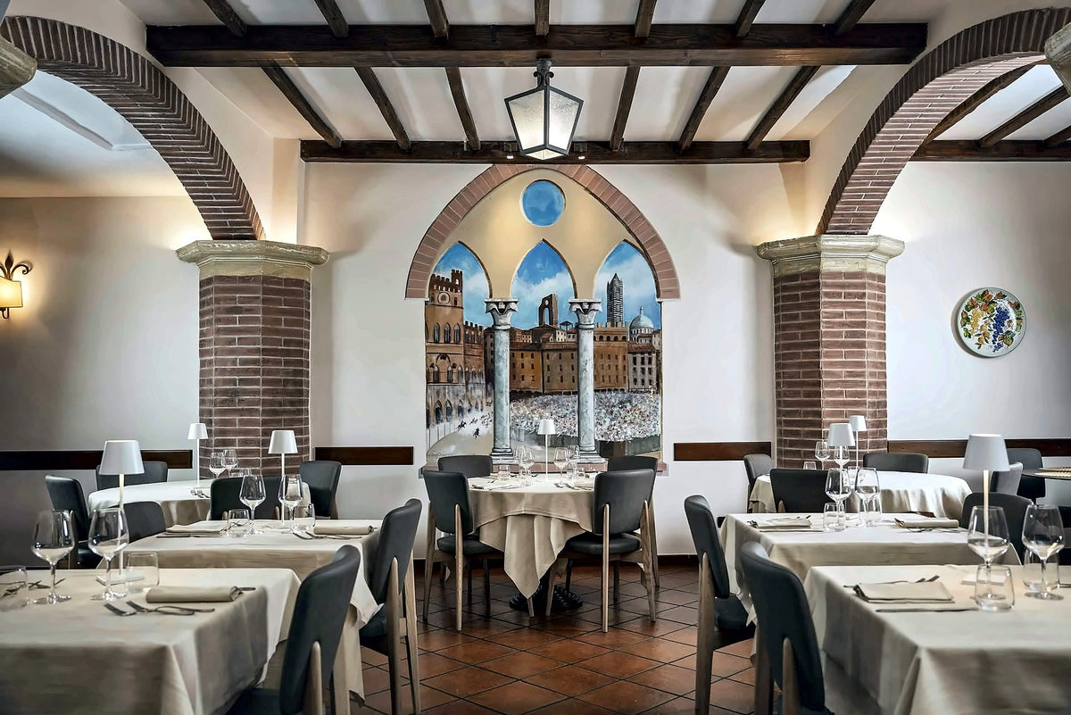 Vaulted dining room with a painted mural at Ristorante Mangia