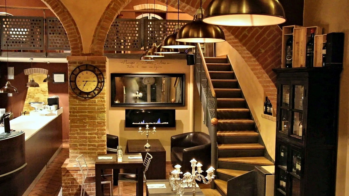 Dining room with a brick arch and staircase at Zest
