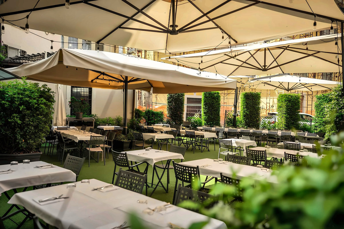 Garden terrace under white umbrellas at Anfiteatro