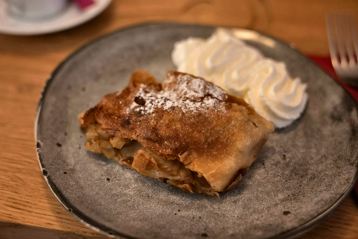 A slice of apple strudel with whipped cream