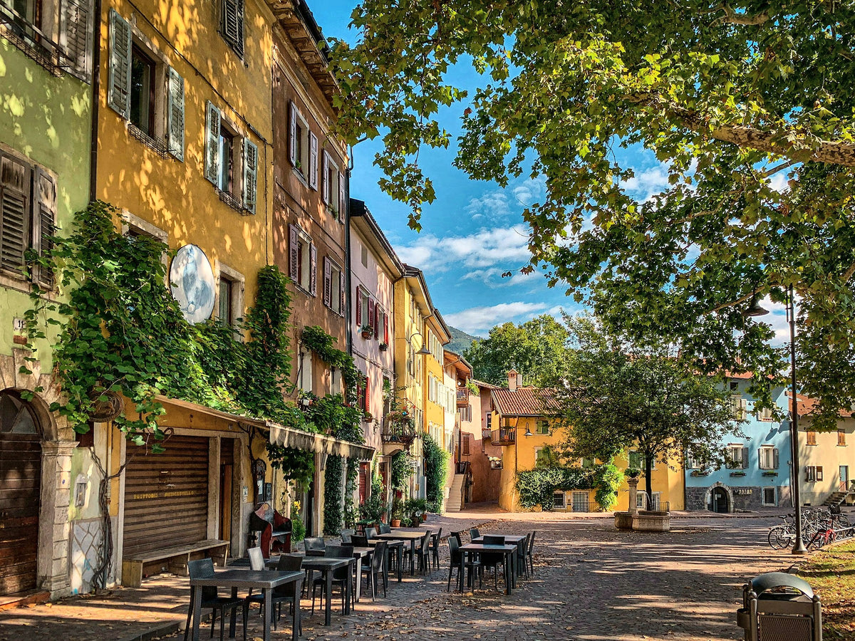 Cafe tables under the trees on a quiet old-town street
