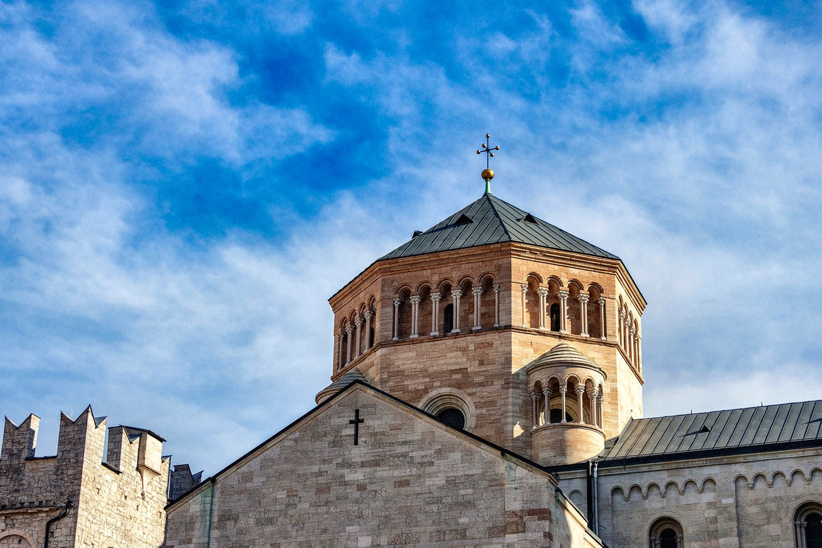 Romanesque dome of the Cathedral of San Vigilio under a blue sky