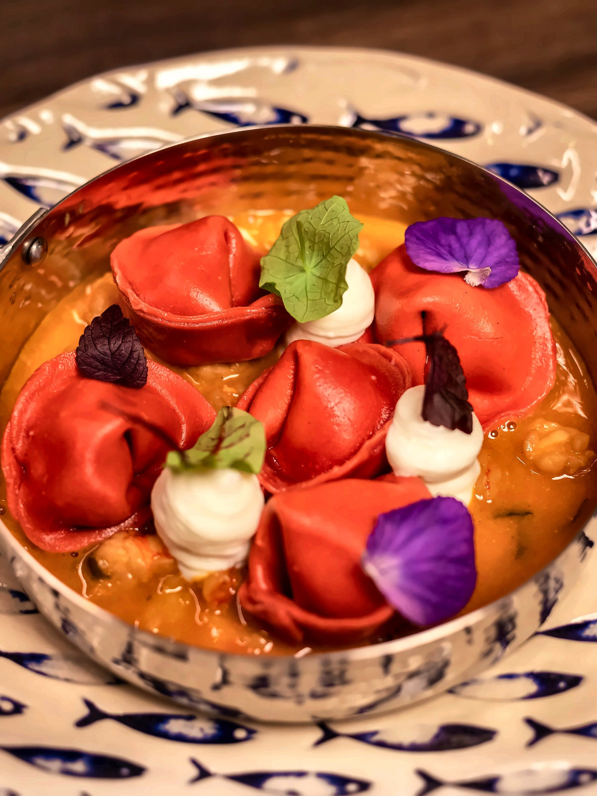 Red ravioli with edible flowers at Contro Break