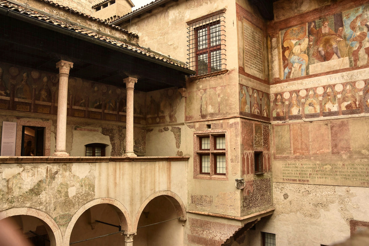 Frescoed walls and a loggia in a medieval courtyard