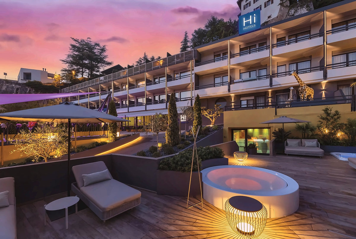Hi Hotels Trento terrace and hot tub at dusk