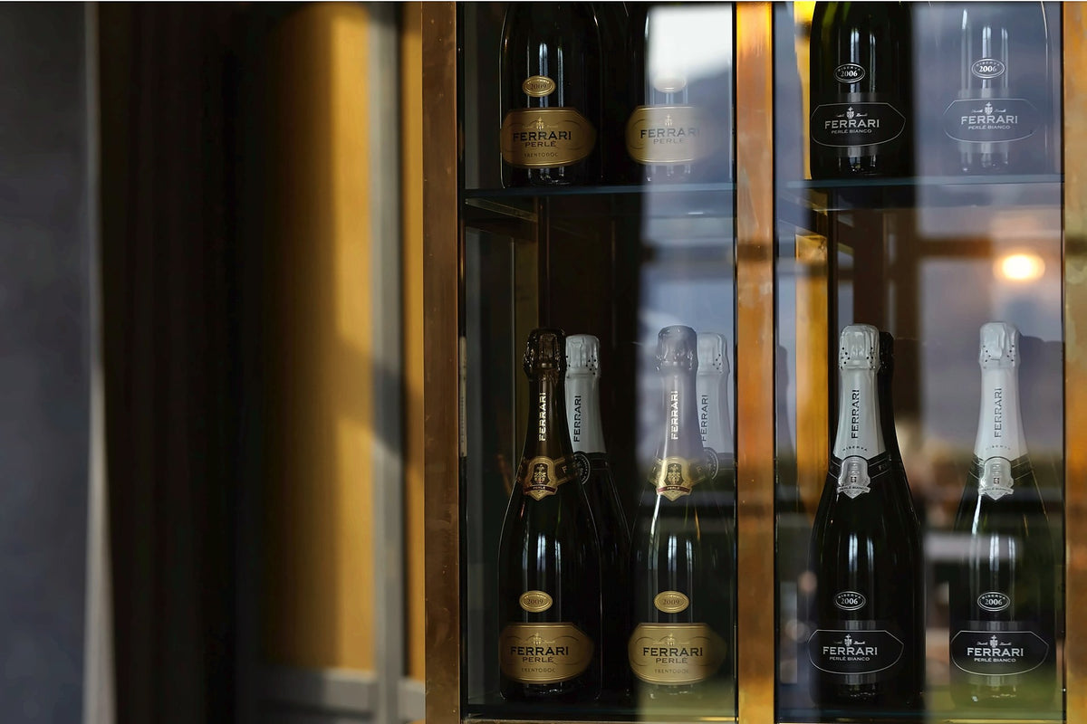 Ferrari Trentodoc bottles in the wine cabinet at Locanda Margon