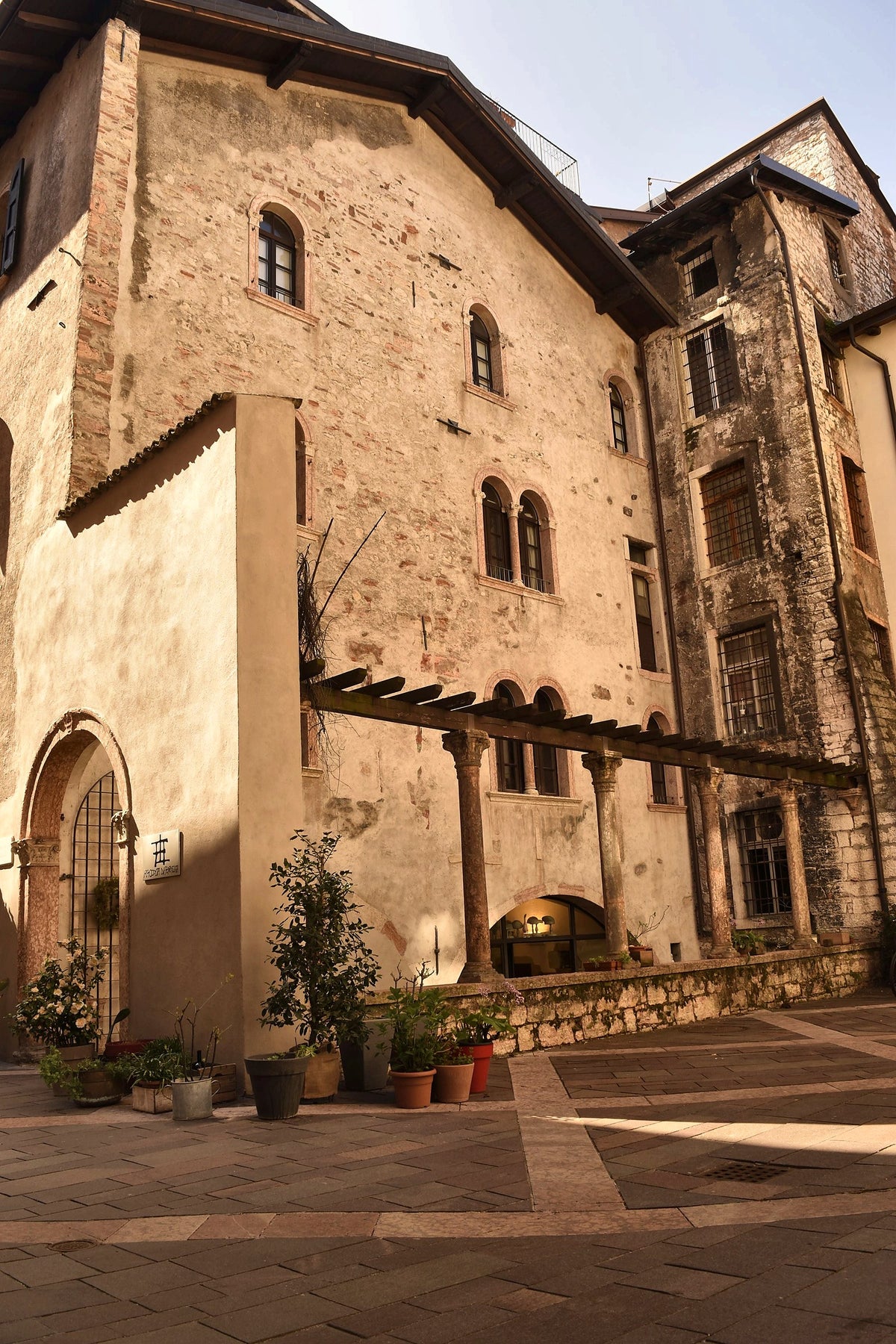 Medieval house with arched windows and potted plants