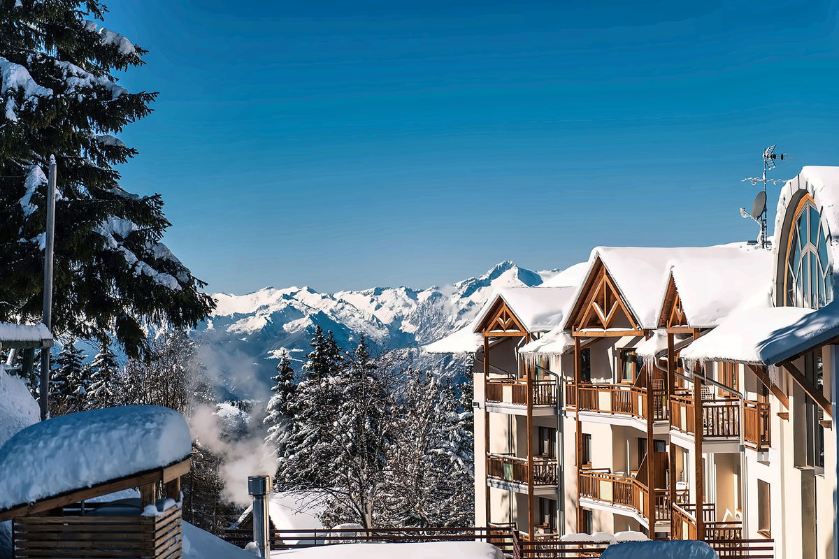 Hotel Montana under snow with the Dolomites behind