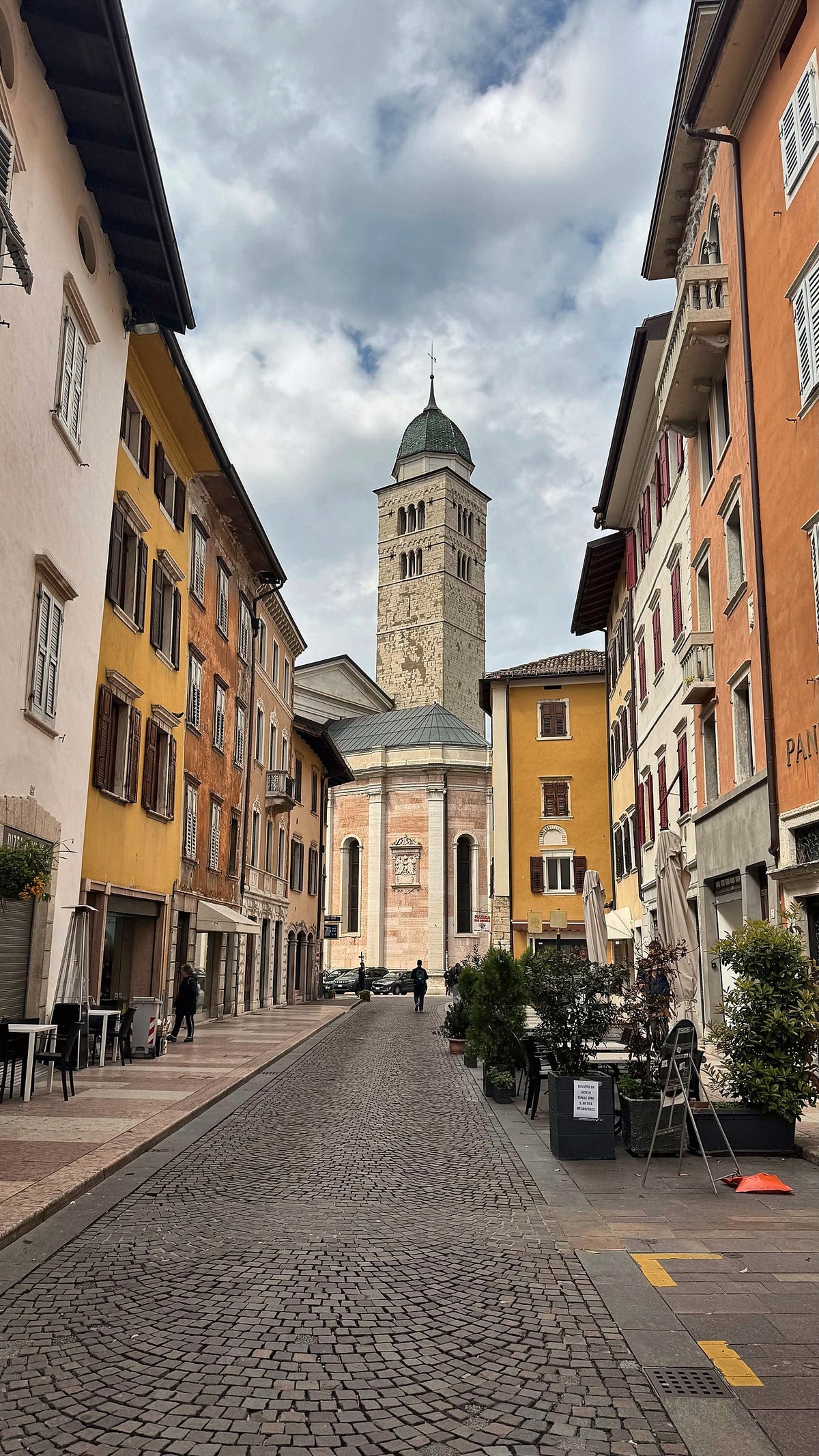 Pastel facades leading to a church tower in the historic centre