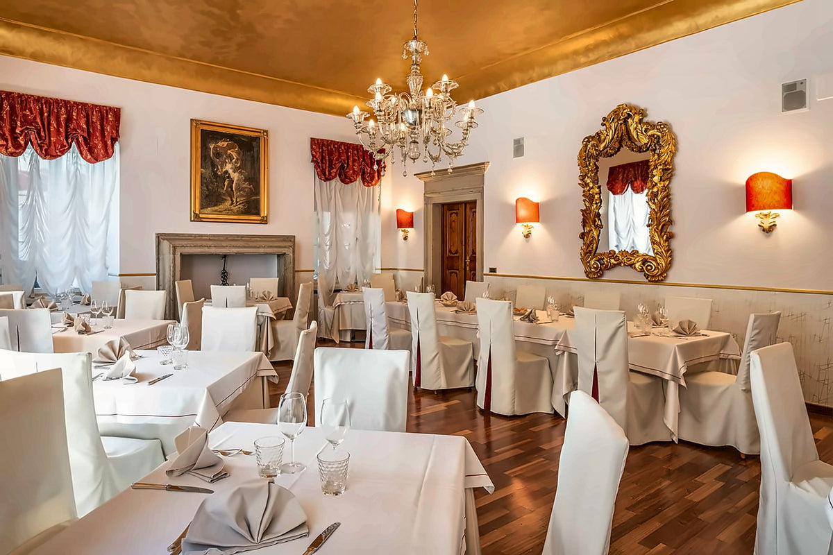 Dining room with chandelier and fireplace at Villa Madruzzo