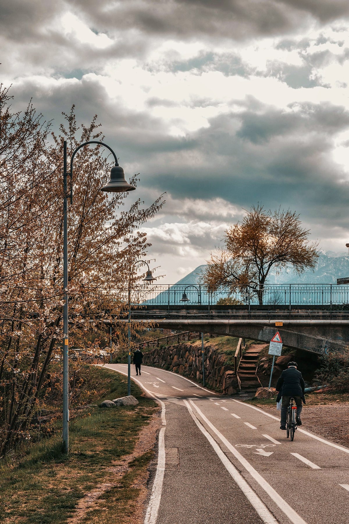 Cycling the riverside bike path among autumn trees