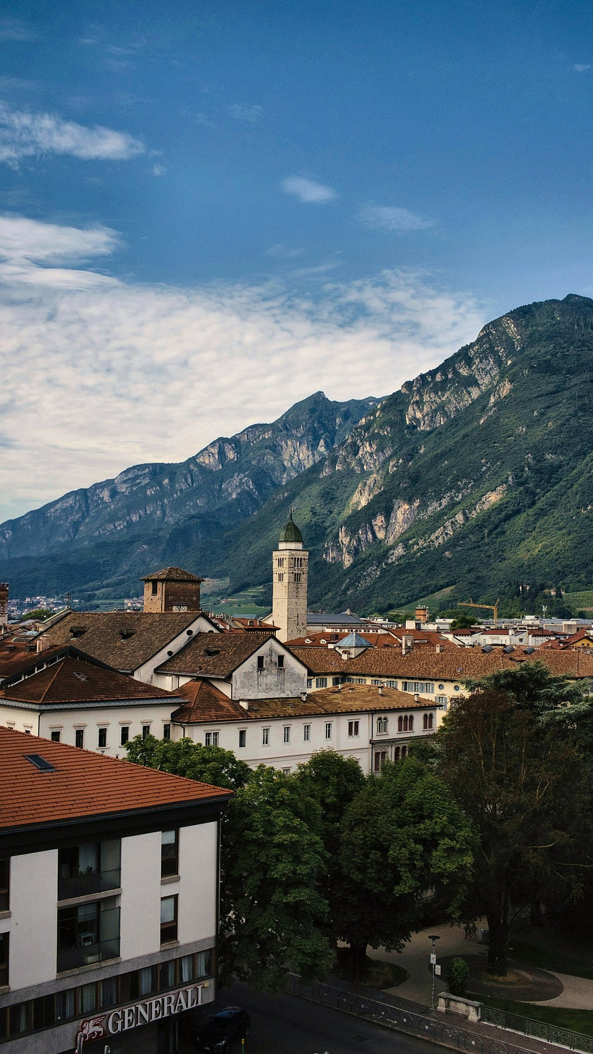 Rooftops and steeples with the mountains behind on a sunny day