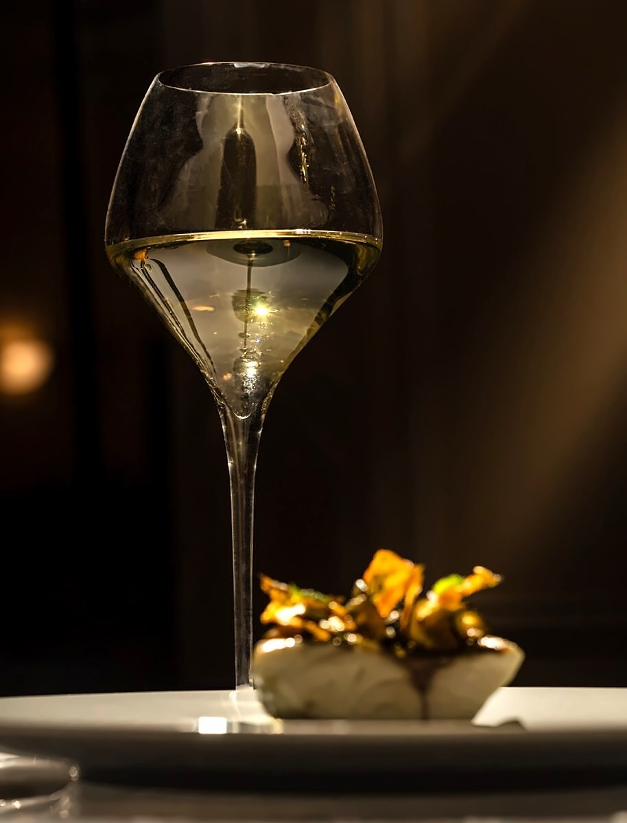 White wine and a plated dish at Antico Ristorante Tommaseo