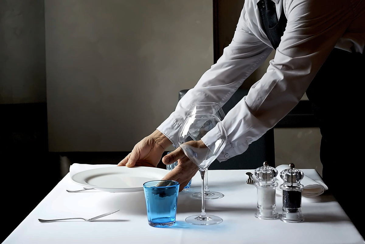 Table being set at Ristorante Ai Fiori