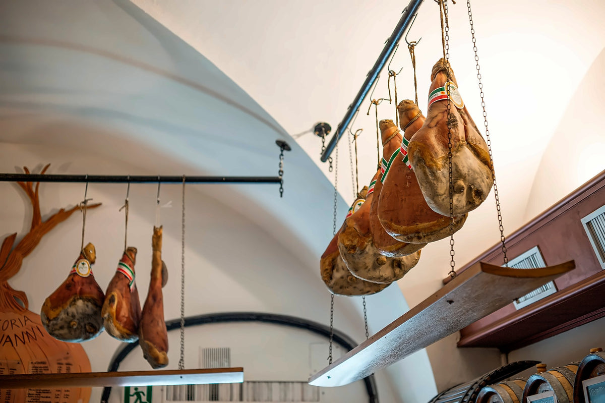 Hams hanging in the dining room at Trattoria da Giovanni
