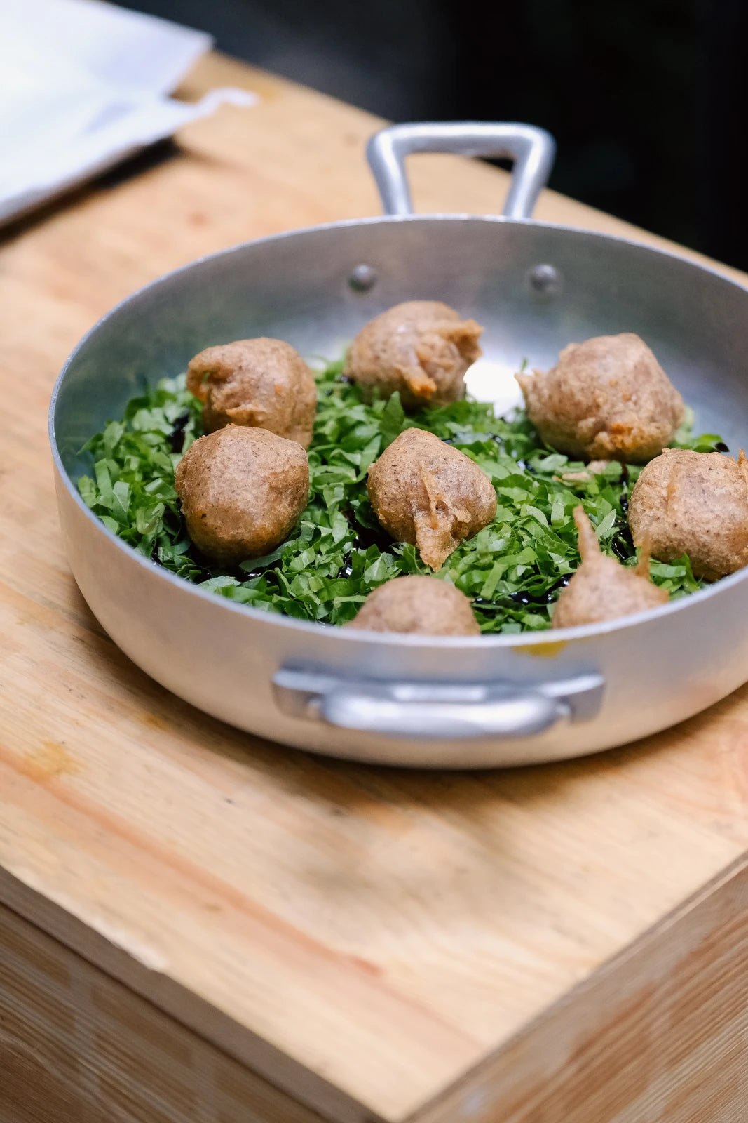 Meatballs with greens in a pan at Latteria San Fedele