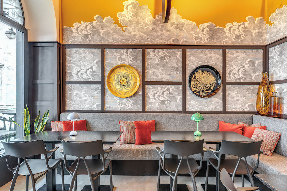 The dining room at Bottega Comacini, under painted clouds