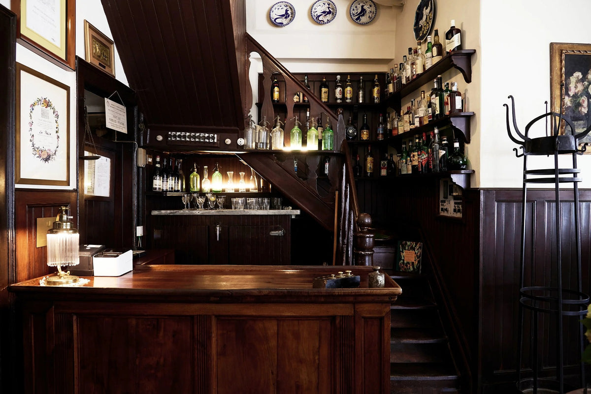 The bar and stairs inside Antica Trattoria della Pesa