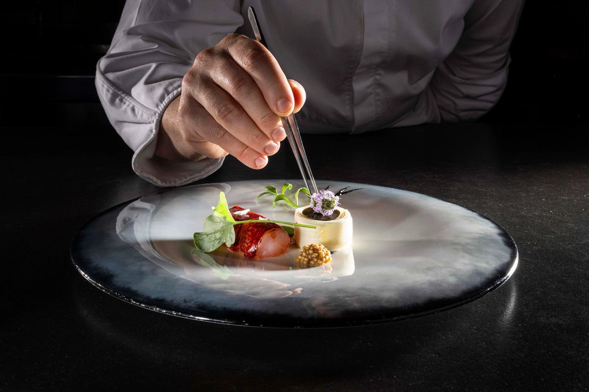Plating a dish at Verso