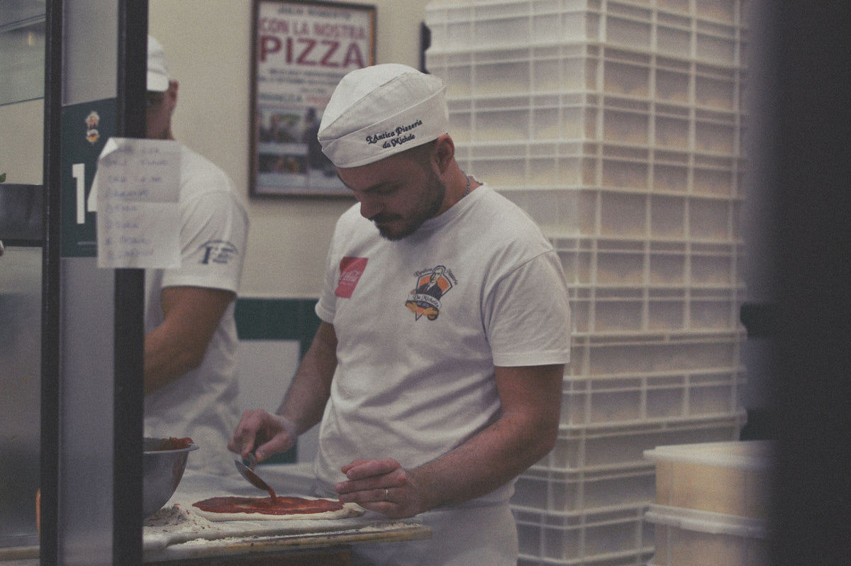 A pizzaiolo at work in a Naples pizzeria