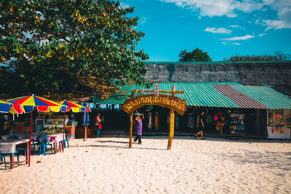 Beach market stalls and umbrellas on a Phuket beach