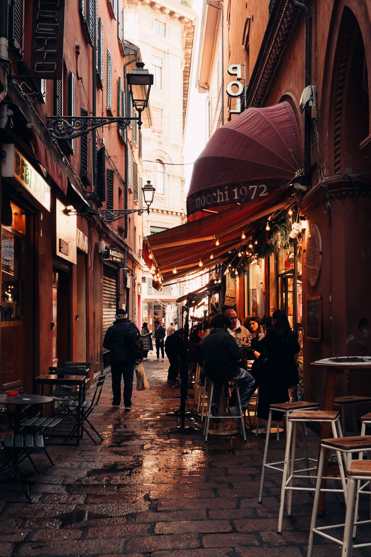 A busy street café in Bologna