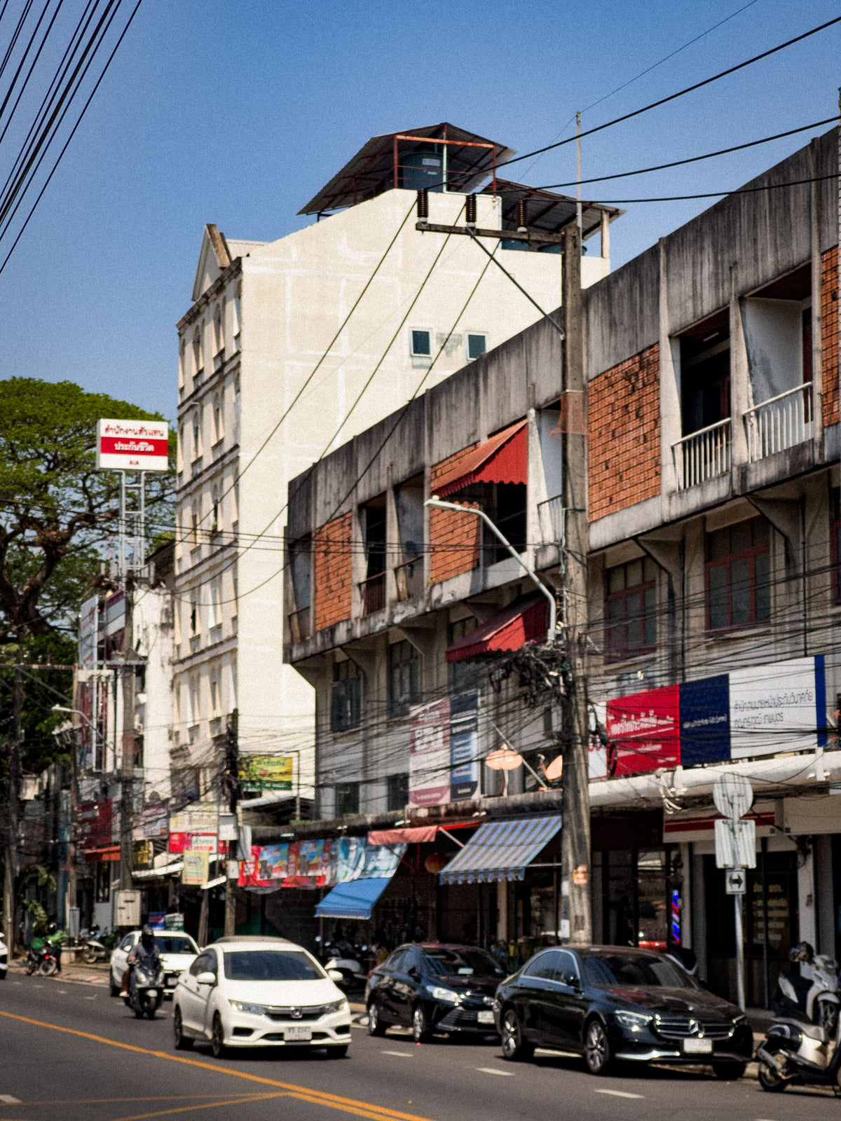 Shophouses and traffic on a street in Phuket Town