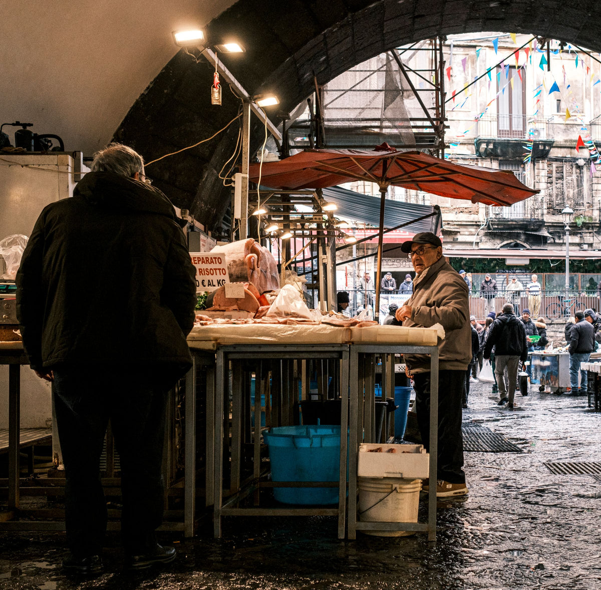 Locals at the fish market under the old arches