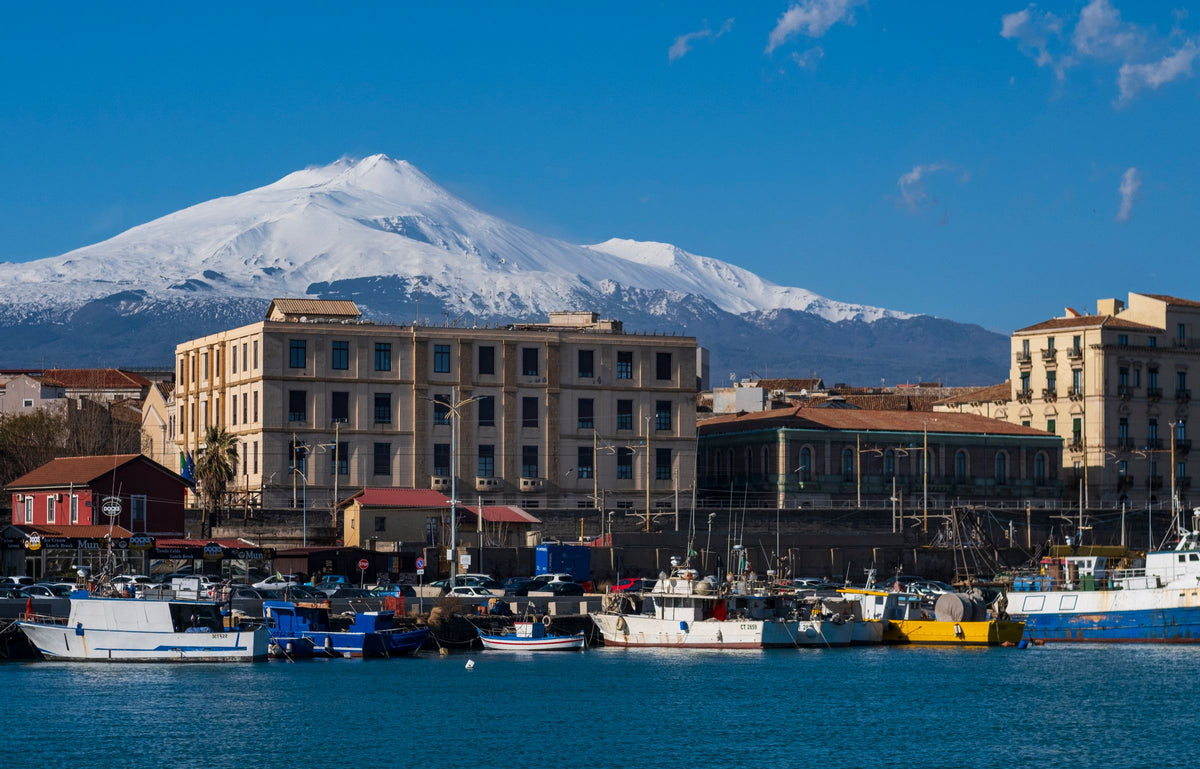 Snowy Etna above the fishing boats of the port