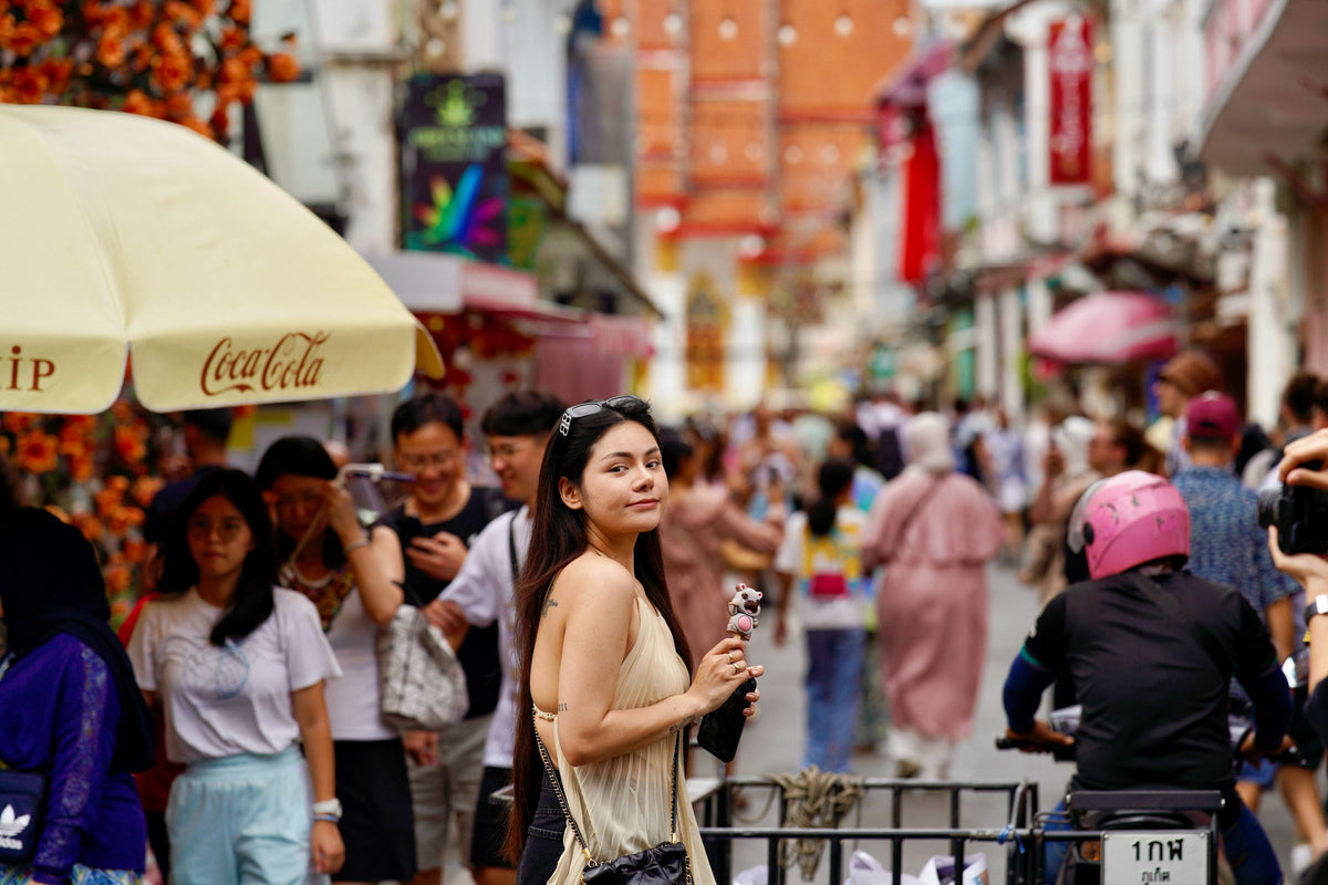 Visitors at a busy street market in Phuket