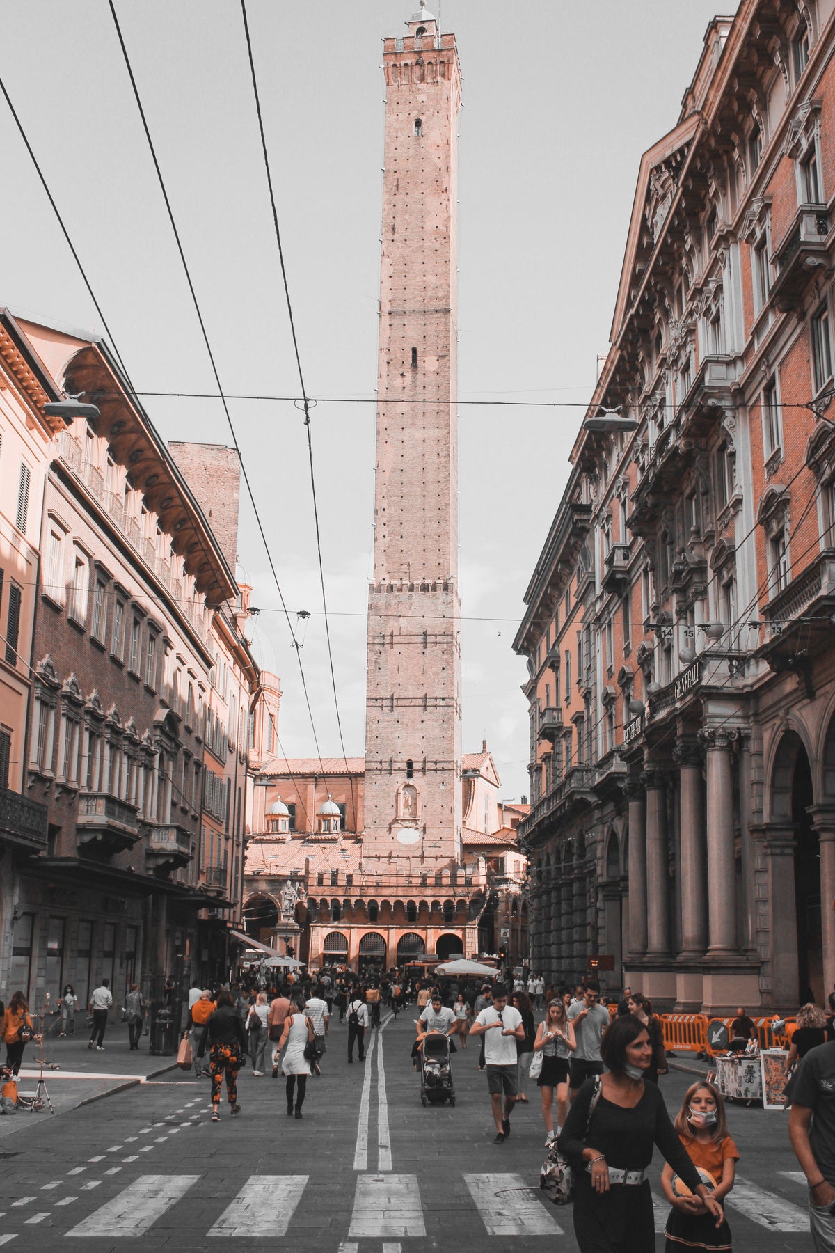 People walking in the street near the Two Towers