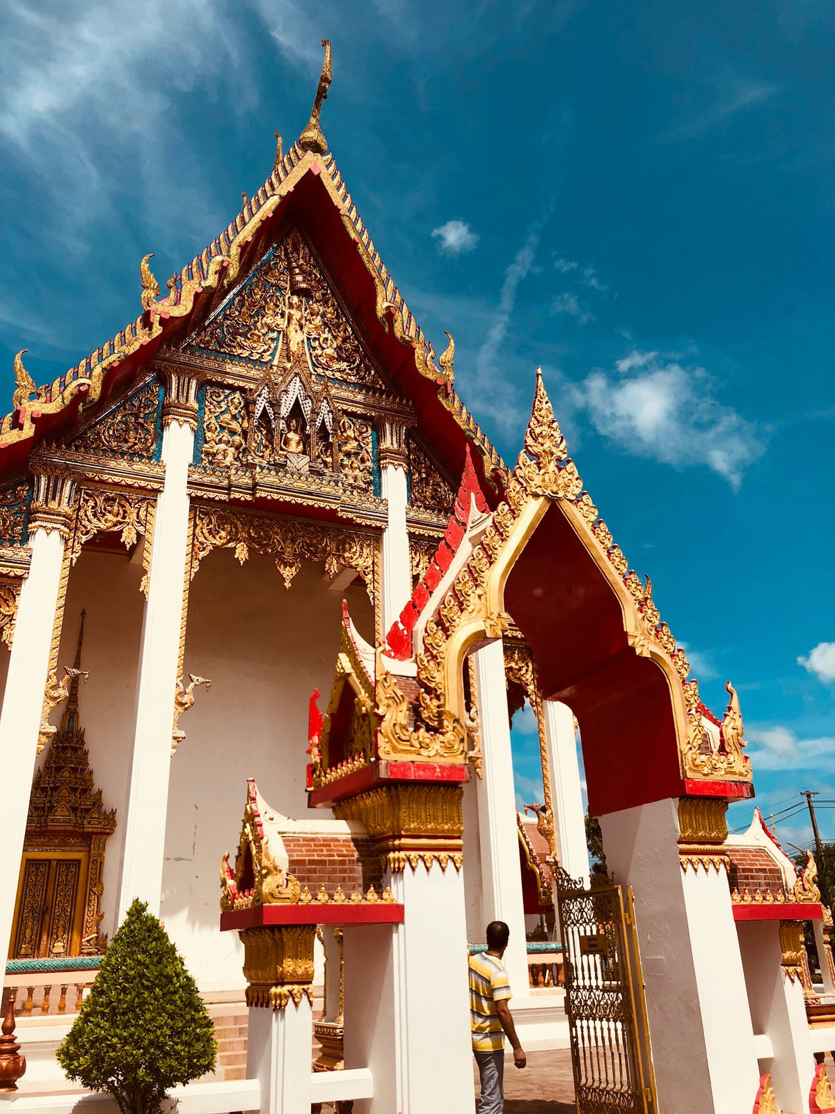 Gilded Buddhist temple under a blue sky in Phuket